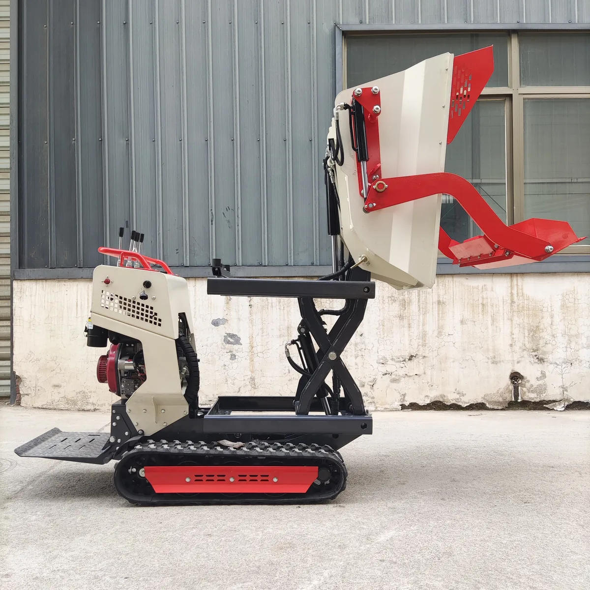 TerraCub Lift 500 mini track dumper — rear view with scissor lift raised and self-loading shovel extended